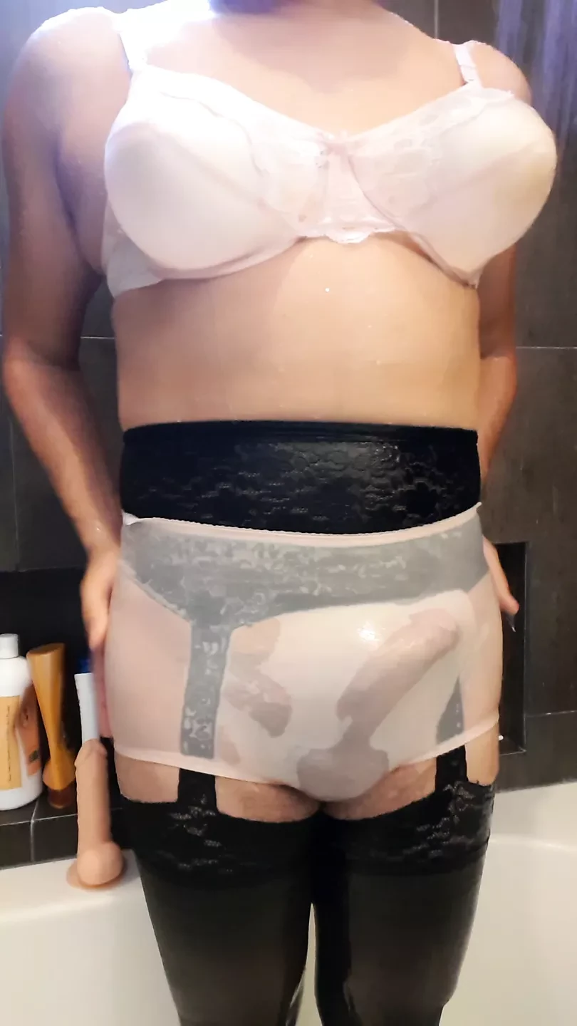 Volledig uitgesneden nylon slipje en roze beha d cup onder de douche
