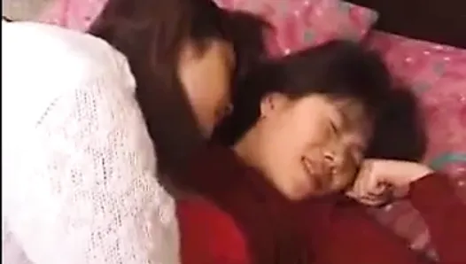 Asian lesbian sucks and fucks with a strapon