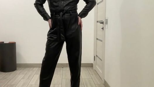 Tranny in a leather jumpsuit romper and high heels BDSM