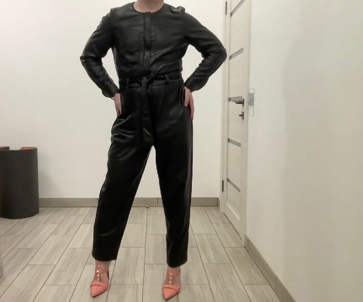 Tranny in a leather jumpsuit romper and high heels BDSM