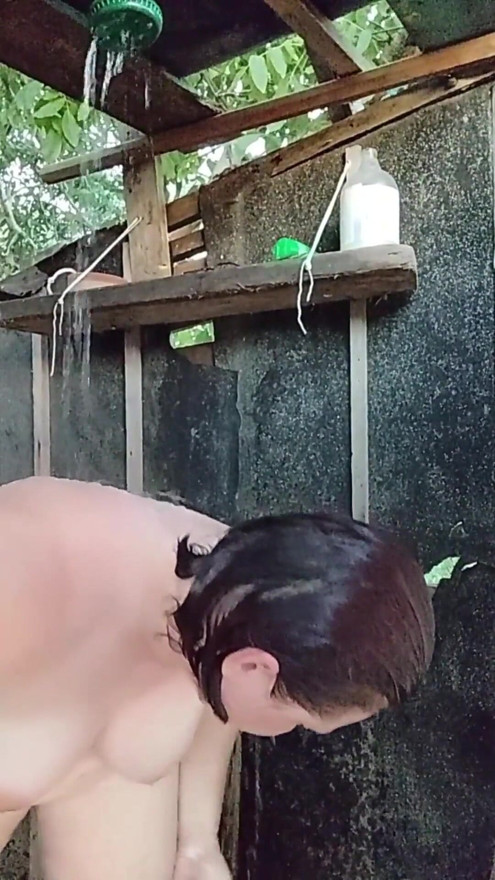 I'm watching a curvy girl wash herself in the street. | Clip 1