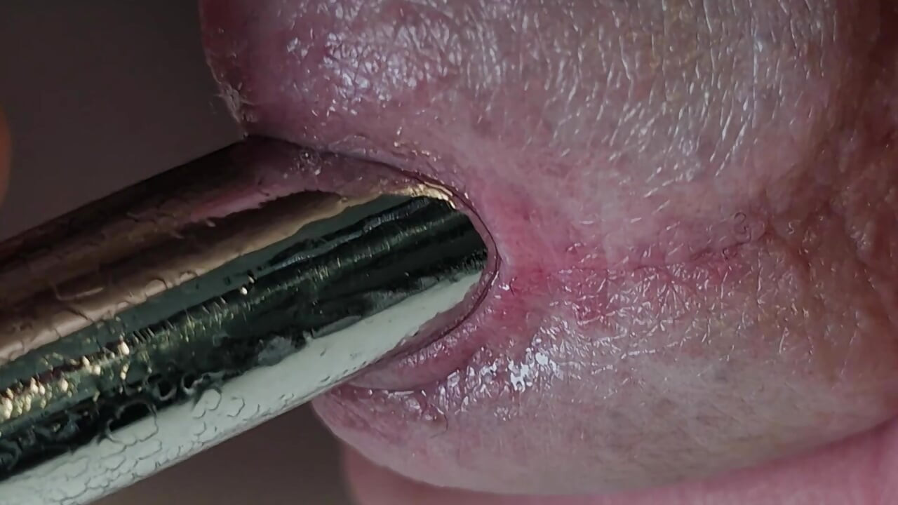 Pulling out extremely tight 14mm urethral teardrop plug close-up.