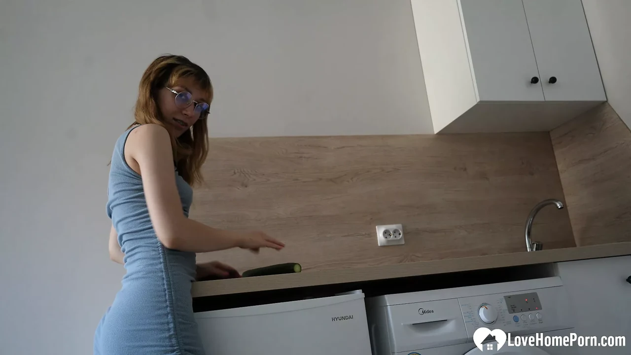 Kinky girl fucks herself with a large cucumber