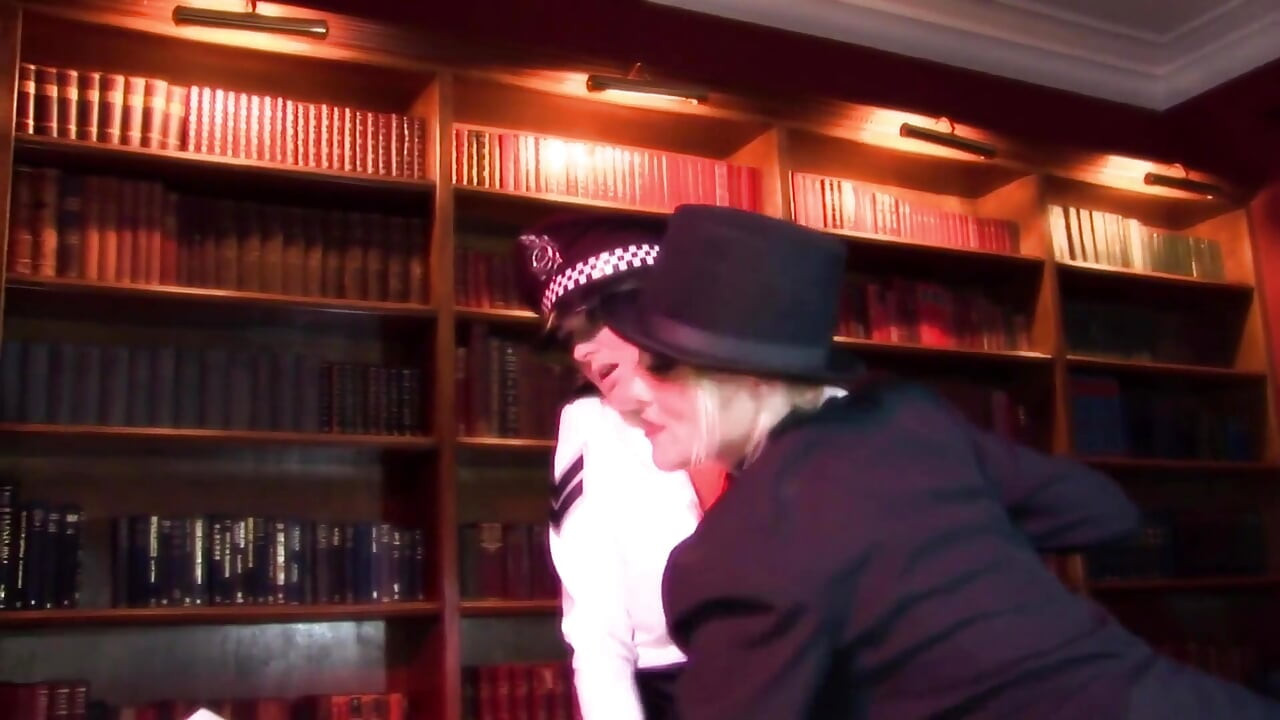 Kinky blonde shoves a stick into sexy police woman's asshole during a lesbian fuck