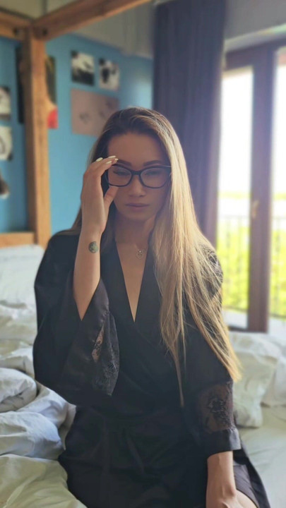Hot asian woman with glasses in silk robe
