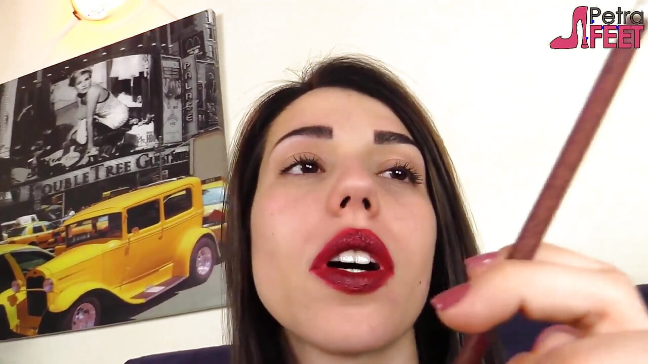 Beautiful Italian girl is smoking a cigar in close up