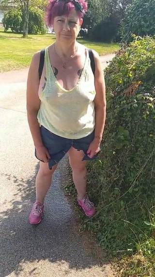 Braless Mature release piss in Public Park