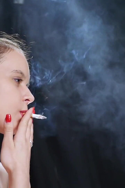 Topless Brunette Smoking in Dramatic Smoke