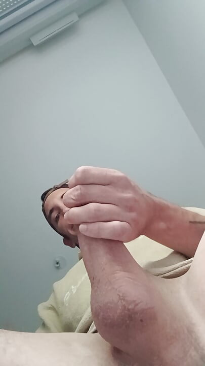 Young guy jerks off his big cock and cums