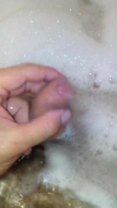 Playing with cock in the bath