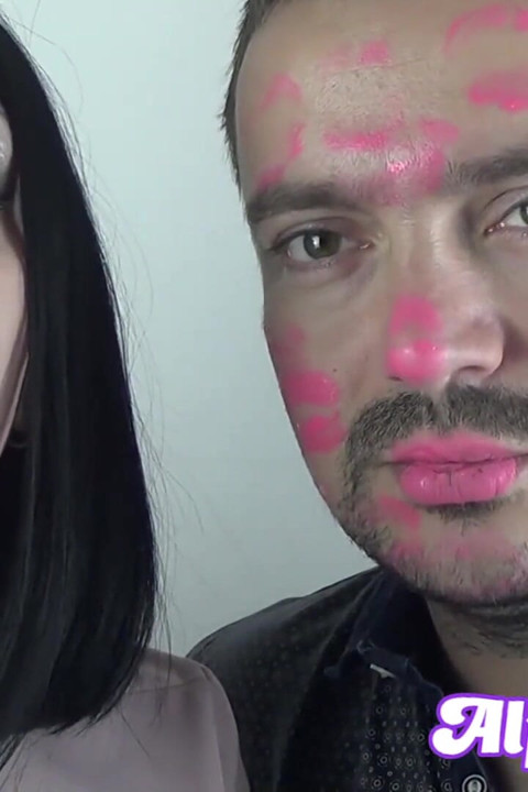 Covering Alex with pink neon shiny lipstick while kissing all over his face