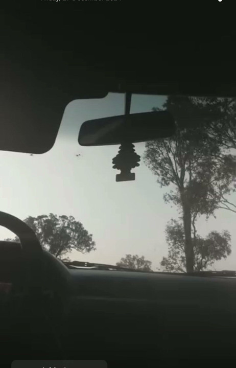 On the windscreen of the car naked parked on the side of the road riding a dildo