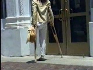 通りで松葉杖で切断されているラクの切断者女性