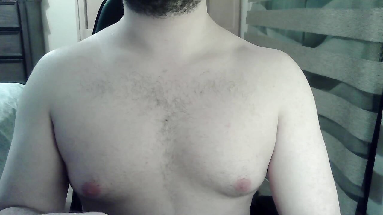 Muscular camboy flexes his muscles and squats