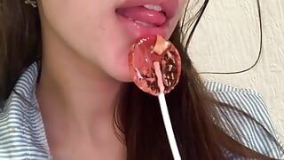 This lustful bitch sucks candy and dreams of a big dick