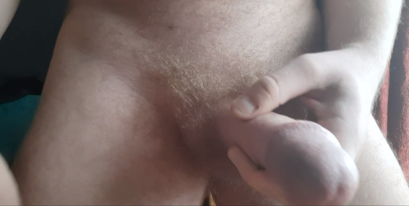 The guy jerks off a powerful cock with a big prick and cums in front of the camera
