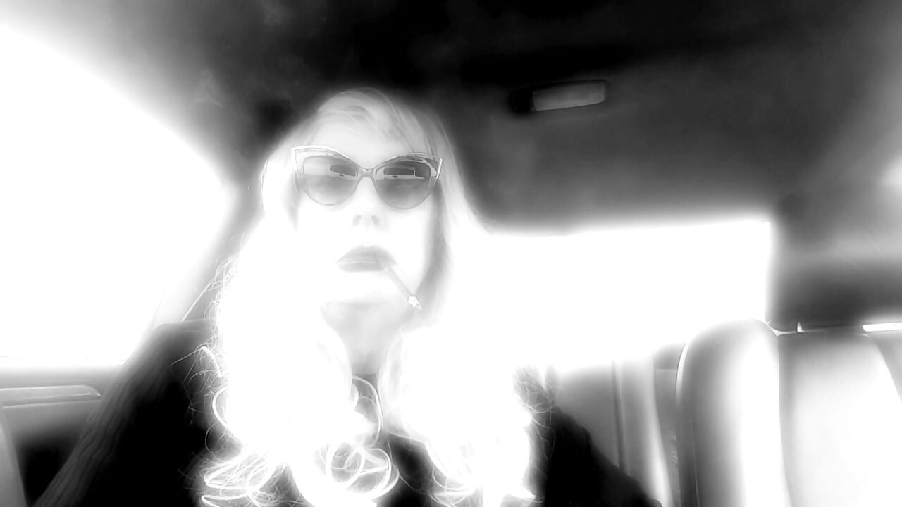 MATURE TG CD SMOKING MORES IN MY RIDE - LOTS OF DANGLING LONG CIGARETTES