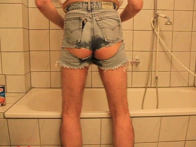 tearing a ripped cut off jeans