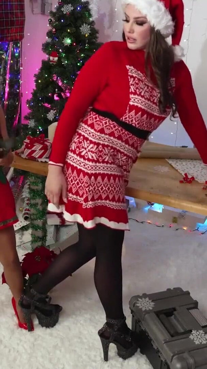 Iconic moment from "Mrs. Claus Surprises The Inventive Elf Sparkle In Her Sex Toy Factory Work Area - Lesbian Christmas"