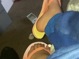 Ebony feet in colorful flip flops