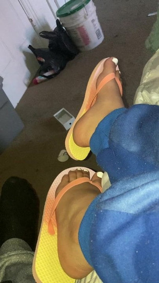 Ebony feet in colorful flip flops