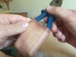 Large blue pliers in foreskin - 2 of 2