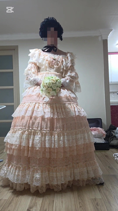 A man dressed as a woman dances in a dress.