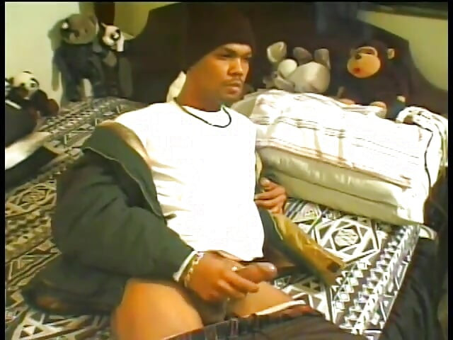 Ghetto thug with wool cap yanks his black tool