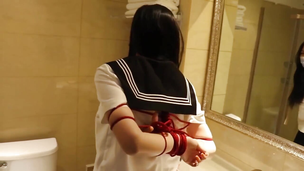 Gg50 - Cute Girl Challenges Herself to Break Free From the Restraints of Ropes and a Single Glove on the Bed.