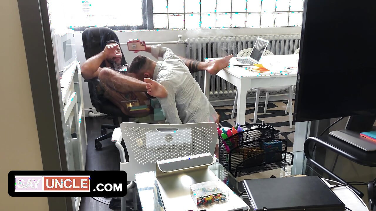 Two muscular coworkers are stuck in the office during lockdown and find a distraction from boredom