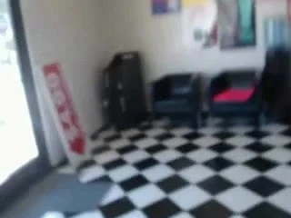 Redhead deepthroats huge cock behind counter of shop
