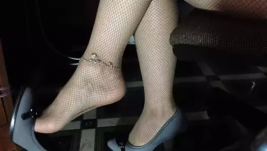 Shoes and legs in tights in a dangling mesh