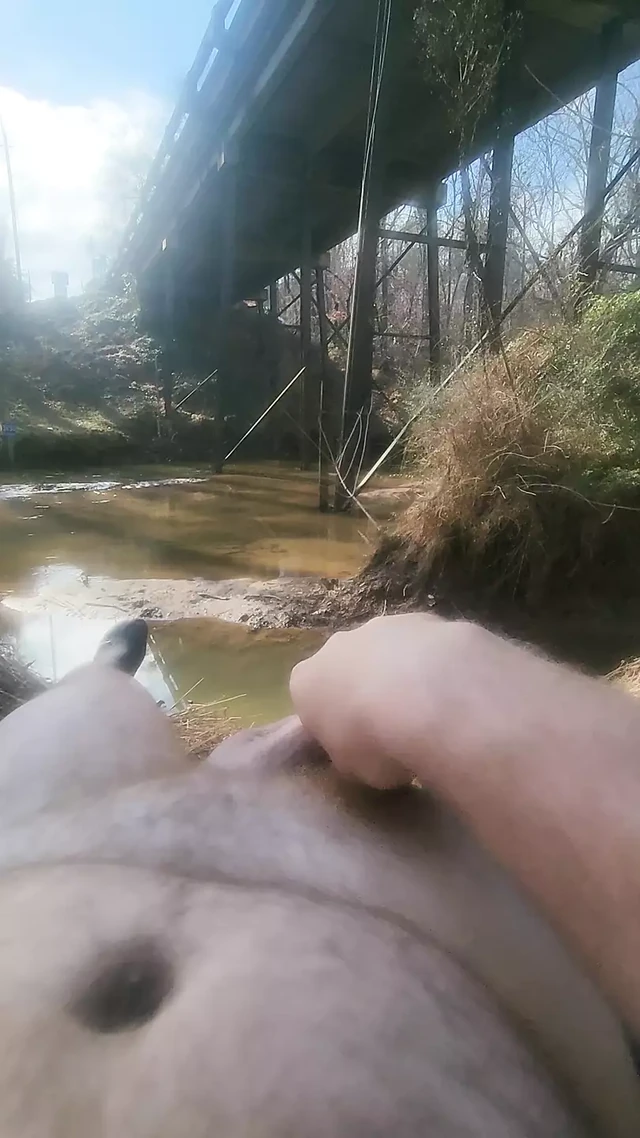 Solo down by the river next to the road