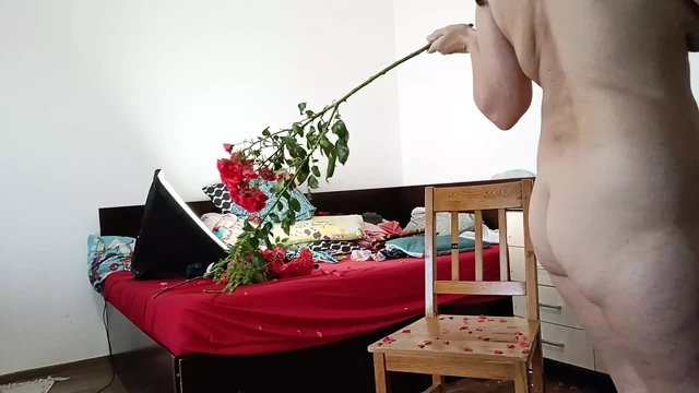 Sexy wife having fun in bedroom with roses. Sexy naked wife preparing food in the kitchen