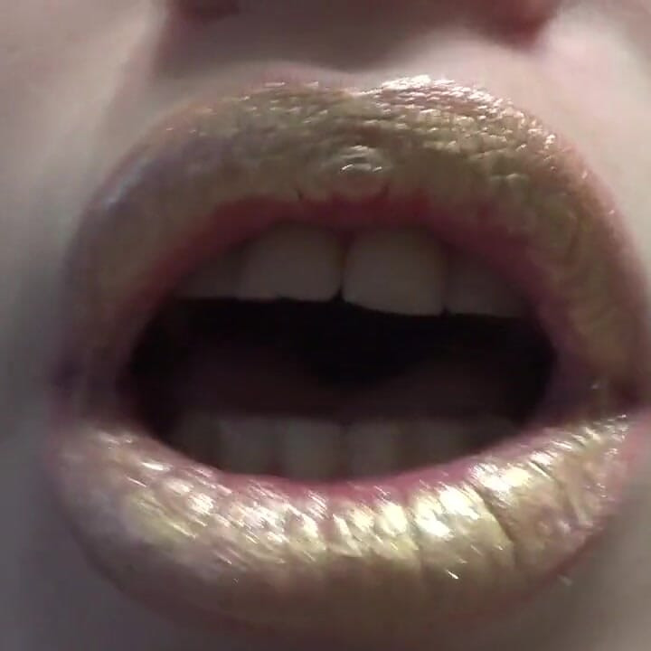 Golden lips teasing and lollipop sucking and licking