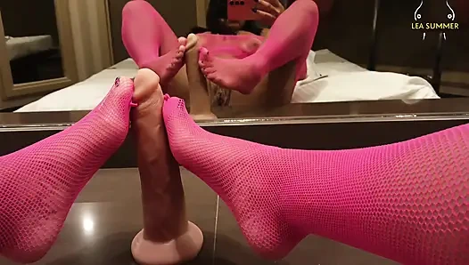 A milf with a large vagina masturbates with her dildo using her feet, then inserts a black dildo.