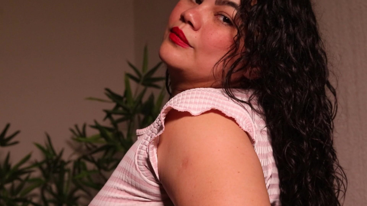 A playful 58-second introduction in a pink top, black panties and white socks, gently caressing my soft curvy body.