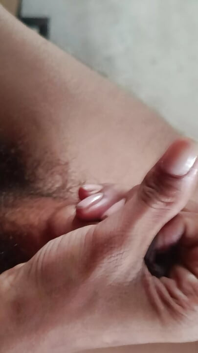The boy is shaking his penis in his hand and ejaculating.