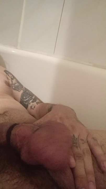 Big tattooed tied up cock , stroking in bathtub