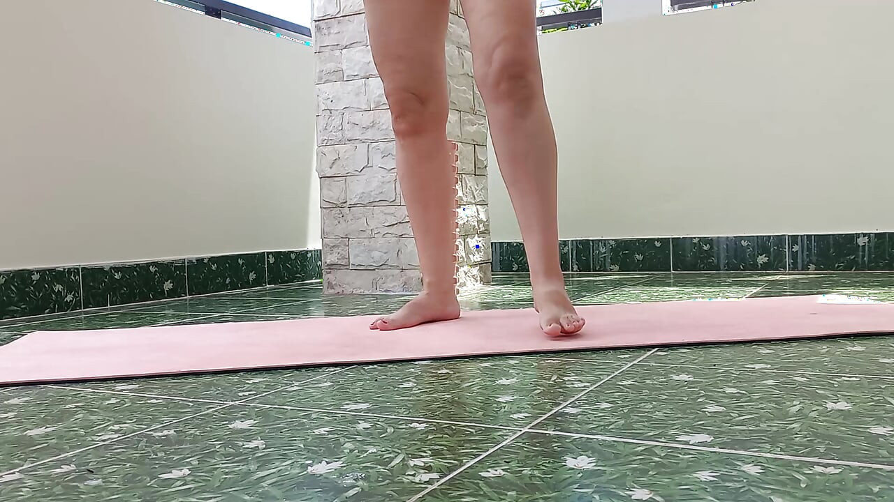 Nice cute Lady doing yoga on her yard. gymnast in red bikini . A wonderful lady. Summer. roof terrace. 304