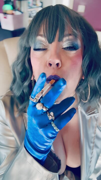 Dressed In Silver & Gloves & Rings Tina Snua Smoke A Supeking Cigarette