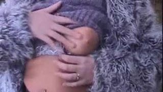 Blonde in Furry Coat Rubs Her Boobs