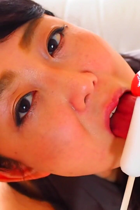 Horny Asian MILF sucking on candy dick