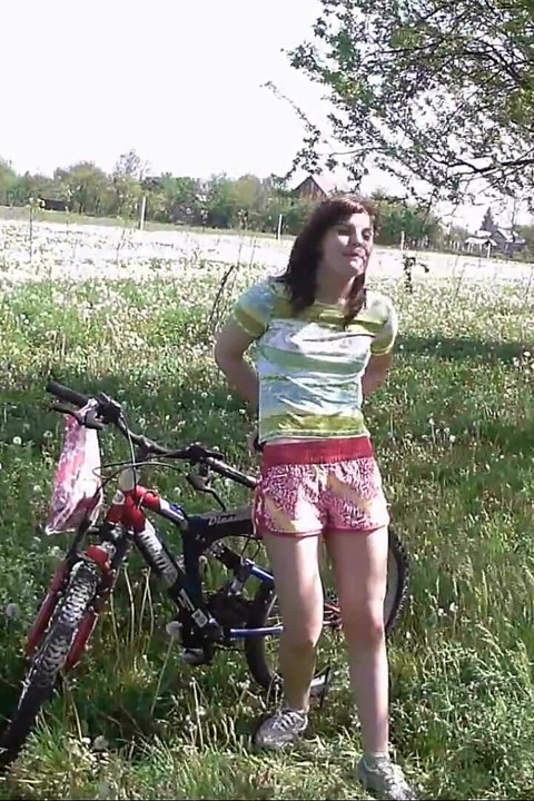 Peeing on her bicycle