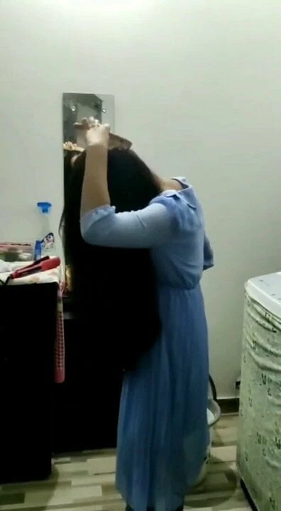 Indian girl with long black hairs combing