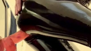 Stacy in latex riding a huge dildo