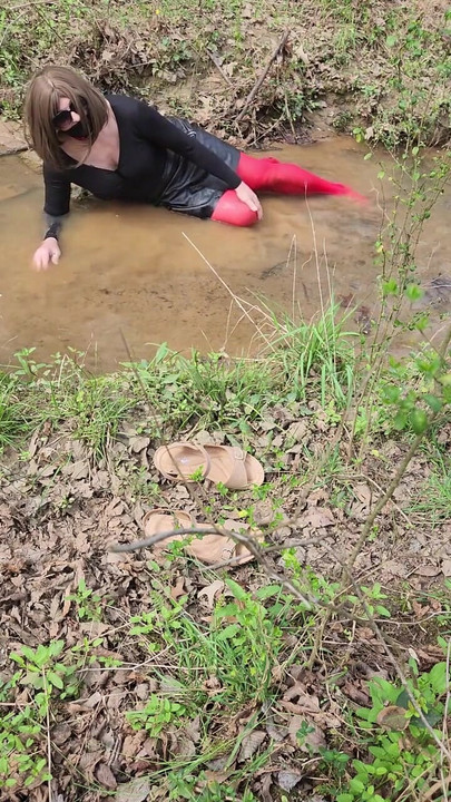 Must-see moment from "Crossdressed outdoors playing in a stream. Wearing pantyhose and miniskirt."
