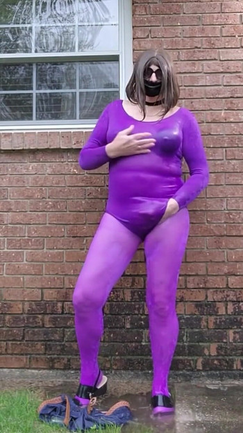 Stunning moment from "Crossdressed outdoors in nylon bodysuit getting wet in the rain."