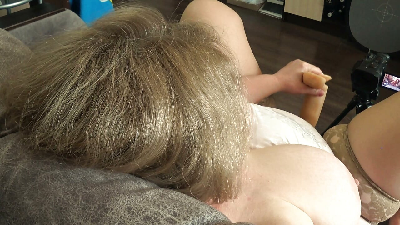 Big Tits From Above. a Camera Watches From the Side as a Plump MILF Masturbates and Records a Video.