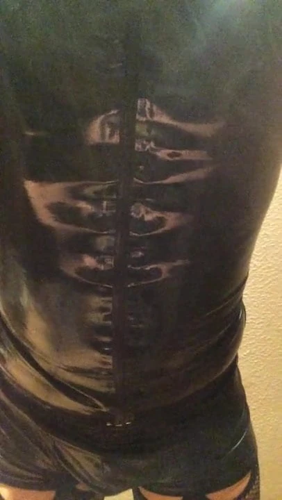 Crossdressing in black latex and fishnets